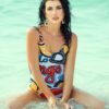 Stylish woman in a colorful swimsuit enjoying a summer day at the beach.